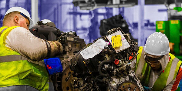 Technicians doing a quality check on a used engine