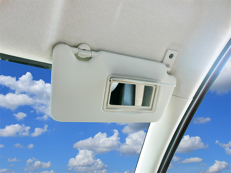 Car sun visor blocking out the sun